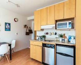 ProjectImage1 Apartment kitchen with table, microwave and stove at Unverferth House